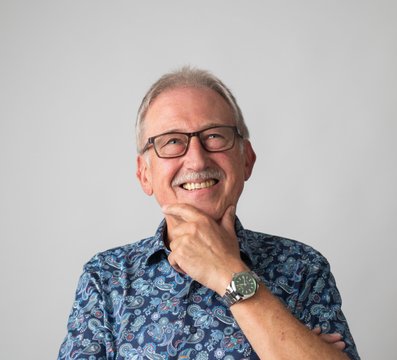 Seniorchef hält linke Hand am Kinn